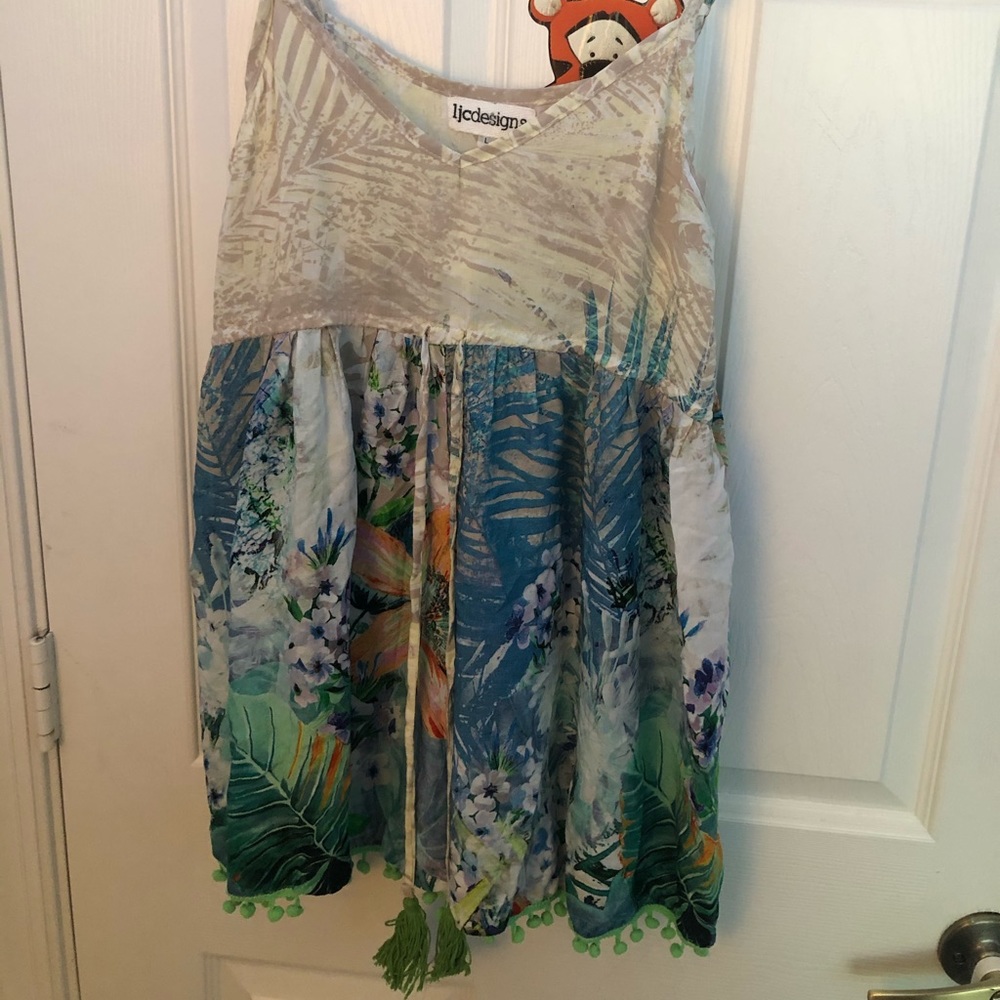 Romper with tropical designs and tassels in front